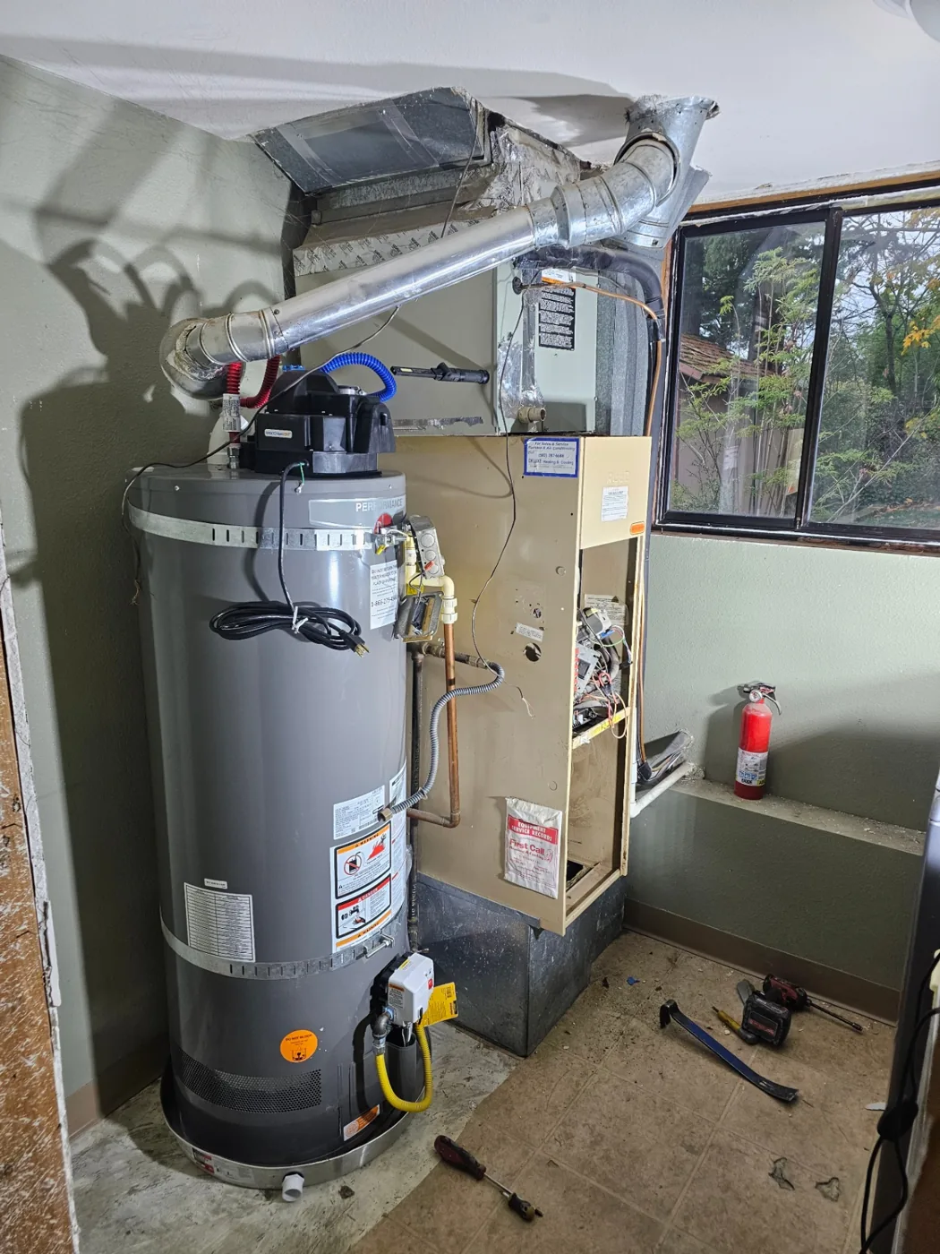 Old gas furnace and water heater prior to replacement in a Vancouver, WA home